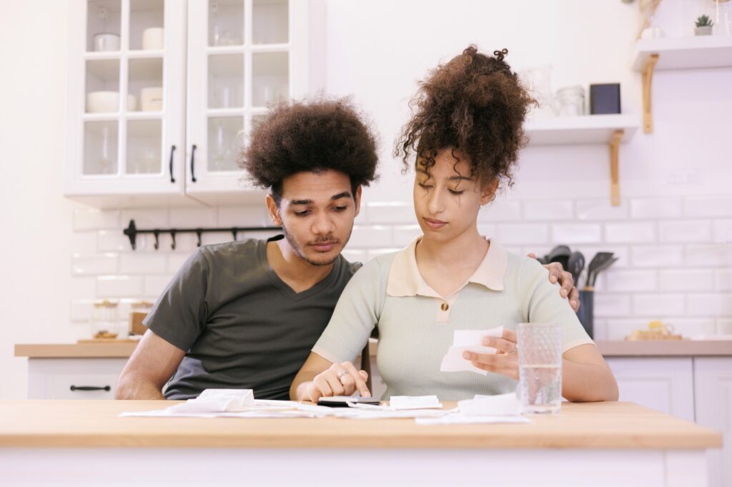man and woman couple pay electricity and rent bills. African American young married person